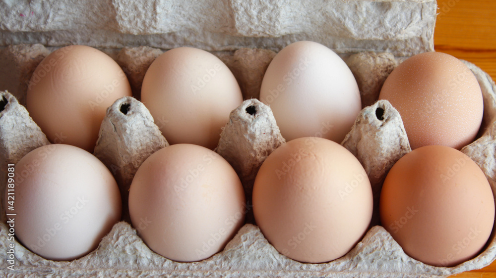 fresh chicken eggs in a cardboard box tray. Eco-friendly egg production. Baking ingredients. Organic chicken eggs - fresh from the manufacturer. fresh chicken eggs in a cardboard box tray. Eco-friendly egg production. Baking ingredients. Organic chicken eggs - fresh from the manufacturer.