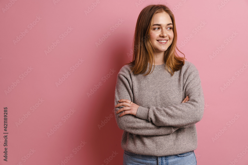 Young ginger smiling woman posing with arms crossed Young ginger smiling woman posing with arms crossed