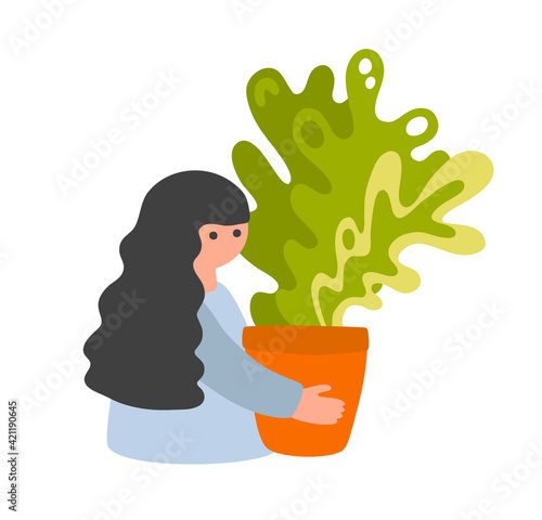Young pretty girl with a big home plant in her hands.