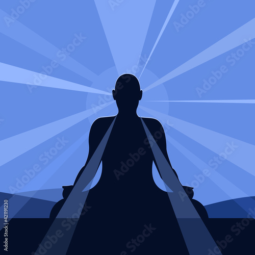 Silhouette of a person doing mediation surrounded by rays and halo