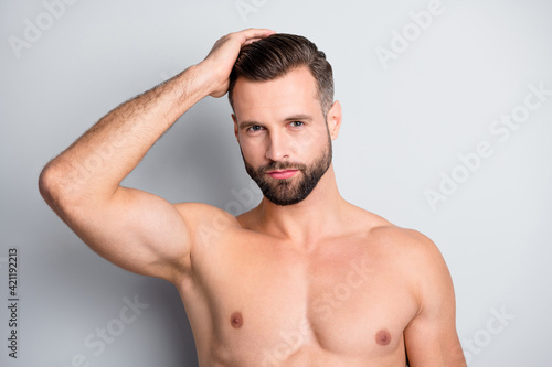 Photo of young handsome man serious hand enjoy haircare treatment conditioner isolated over grey color background