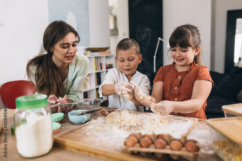 mother and children baking together at home