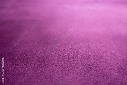 Close view of magenta colored faux suede fabric