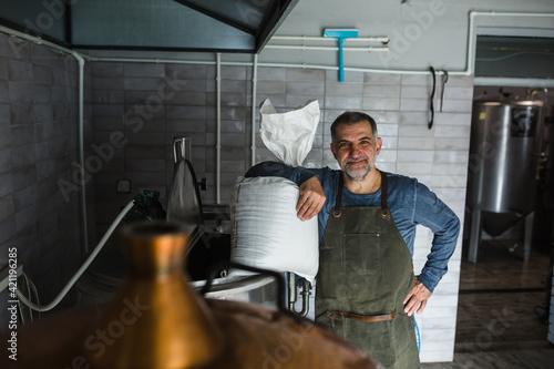 man working in mini craft brewery
