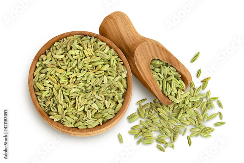 Dried fennel seeds in wooden bowl isolated on white background with clipping path. Top view. Flat lay
