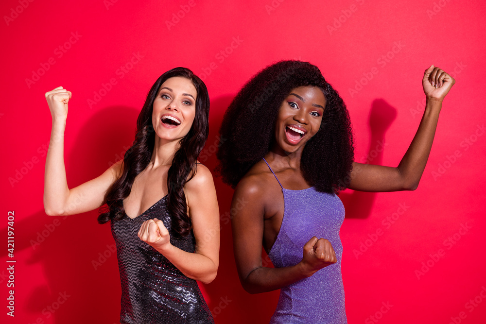 Photo of hooray nice brunette hairdo ladies hands fists wear bright tops isolated on red color background Photo of hooray nice brunette hairdo ladies hands fists wear bright tops isolated on red color background