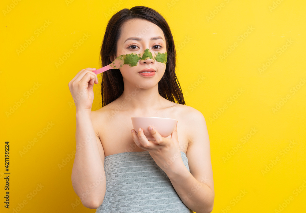 Young girl masked to exfoliate, beautify herself Young girl masked to exfoliate, beautify herself