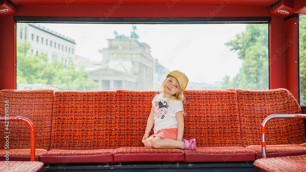 a little girl drives a tourist bus in berlin