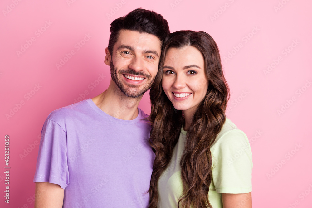 Portrait of attractive sweet cheerful couple embracing together forever isolated over pink pastel color background