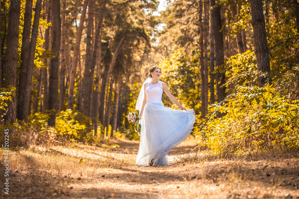 bride with a bouquet is walking the green park bride with a bouquet is walking the green park