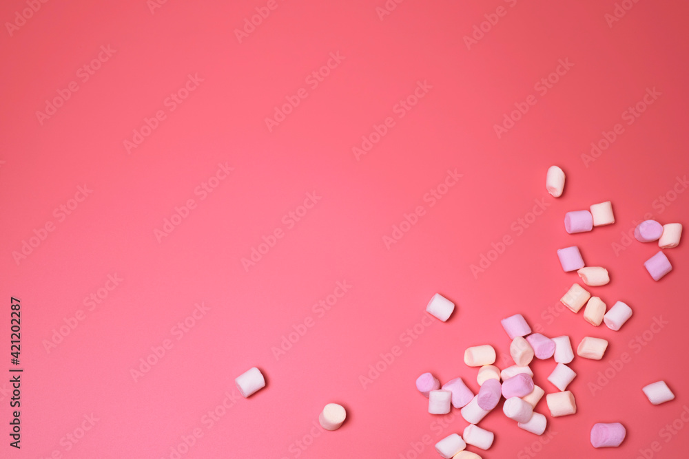 Marshmallows on the pink background, with free space for text. Top view, colorful flat lay. Beautiful background for birthday, holiday cards, for banners. Template for social media. Marshmallows on the pink background, with free space for text. Top view, colorful flat lay. Beautiful background for birthday, holiday cards, for banners. Template for social media.