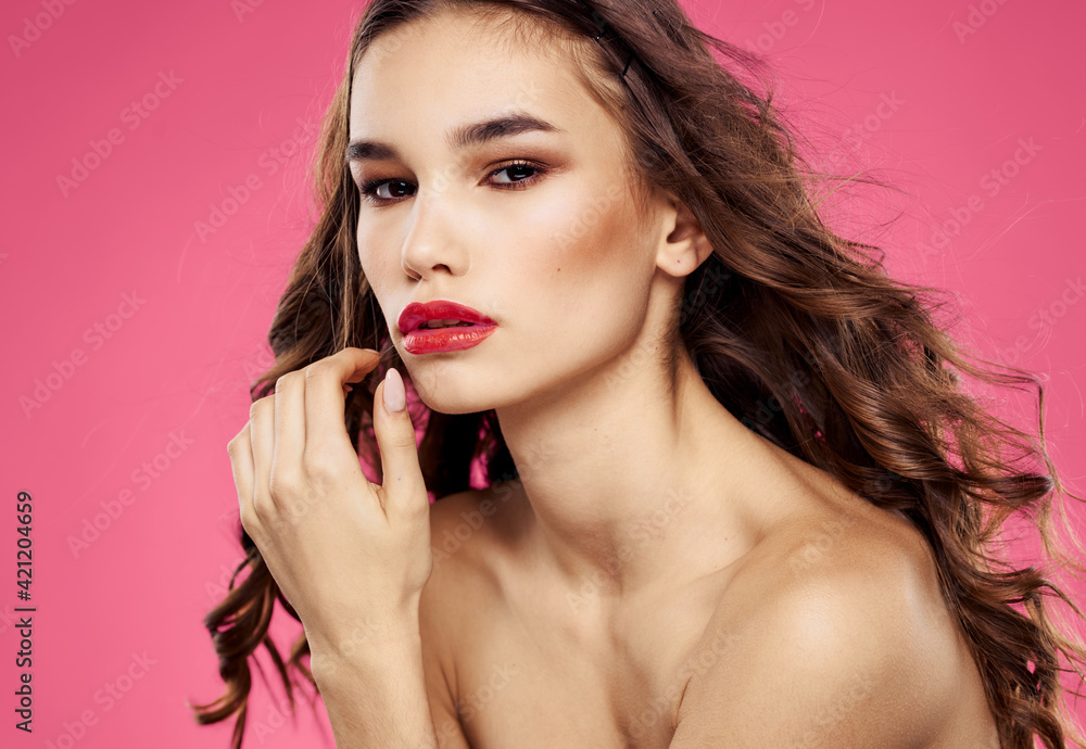 Sexy brunette model pink background red lips bared shoulders Sexy brunette model pink background red lips bared shoulders