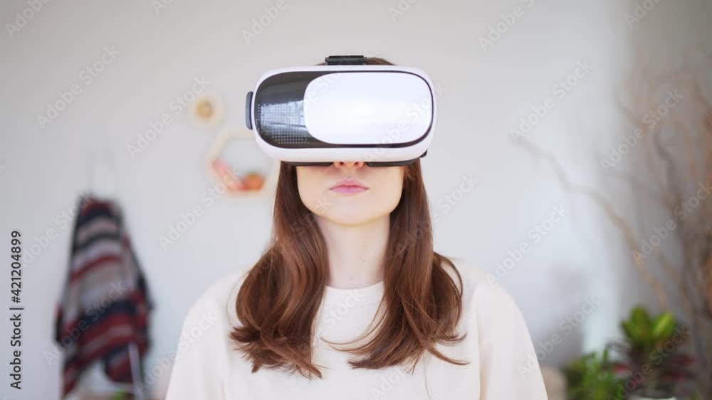 A young woman in a white virtual reality headset. A close-up of a person in cyberspace A young woman in a white virtual reality headset. A close-up of a person in cyberspace