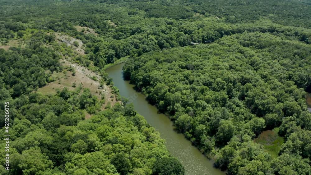Drone flight above a river surrounded by dense green forest. Aerial view of Ropotamo Natural Reserve in Bulgaria. Drone flight above a river surrounded by dense green forest. Aerial view of Ropotamo Natural Reserve in Bulgaria.