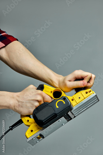 yellow electric wood planer slicer cutting machine isolated on gray background