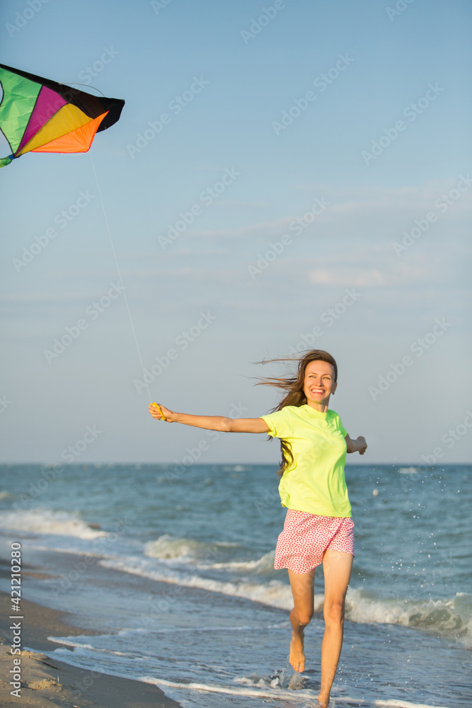Woman running with a kite
