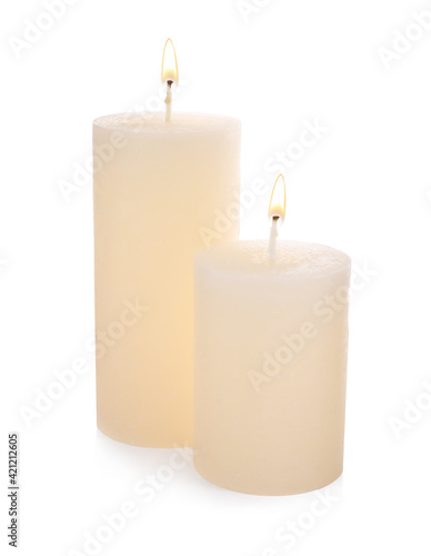 Stylish elegant beige candles on white background