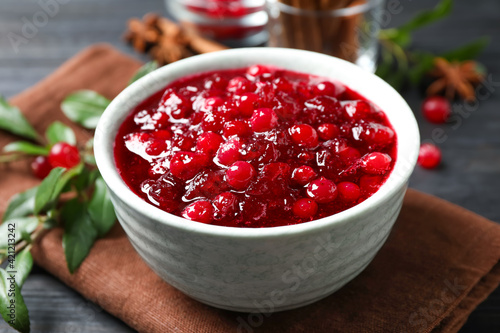 Fresh cranberry sauce served in bowl on table