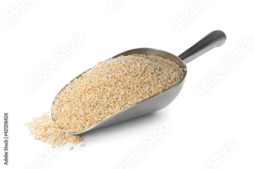 Metal scoop with sesame seeds on white background photo