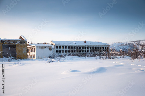 Abandoned apartment buildings in the ghost town Kadykchan, famous for coal mines, Kolyma, Magadan region, during sunny winter day