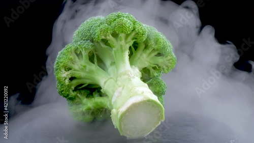 Broccoli Vegetable roatating on a black background photo