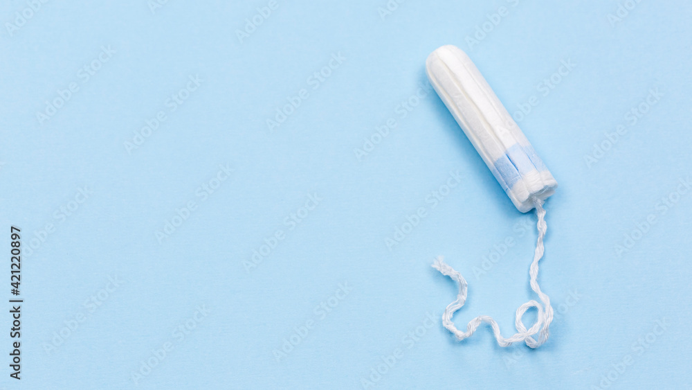 White tampon on the blue background, medical banner White tampon on the blue background, medical banner