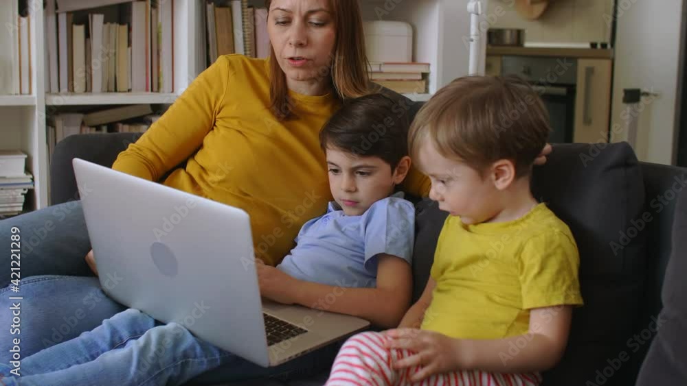 mother and her sons using laptop computer