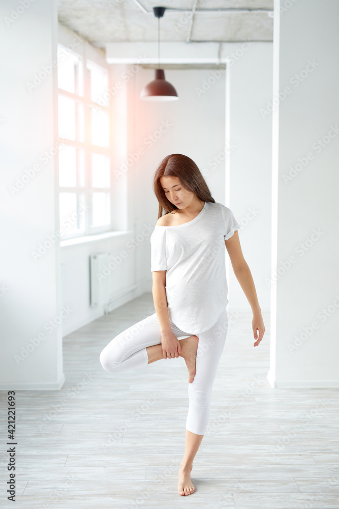 flexible asian chinese pregnant lady stretching body and performing yoga poses postures flexible asian chinese pregnant lady stretching body and performing yoga poses postures
