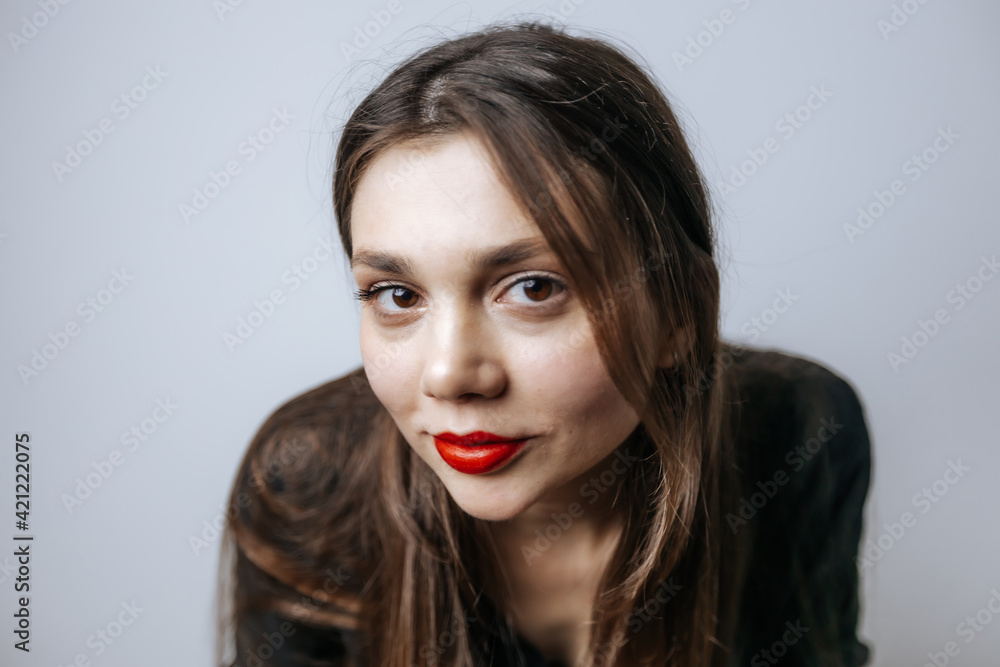 Portrait of a beautiful girl with red lips, big eyes and dark long hair Portrait of a beautiful girl with red lips, big eyes and dark long hair