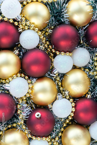 Gold, white and red Christmas balls with gold Christmas beads. Christmas background. New Year or Xmas concept. Top view.