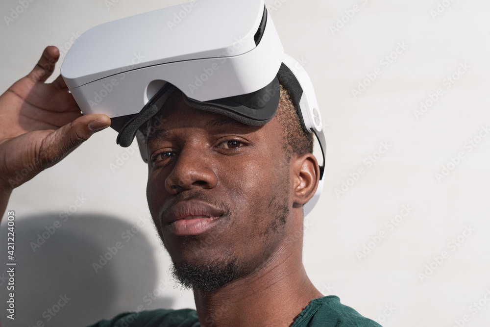 African gamer in vr glasses looking at camera