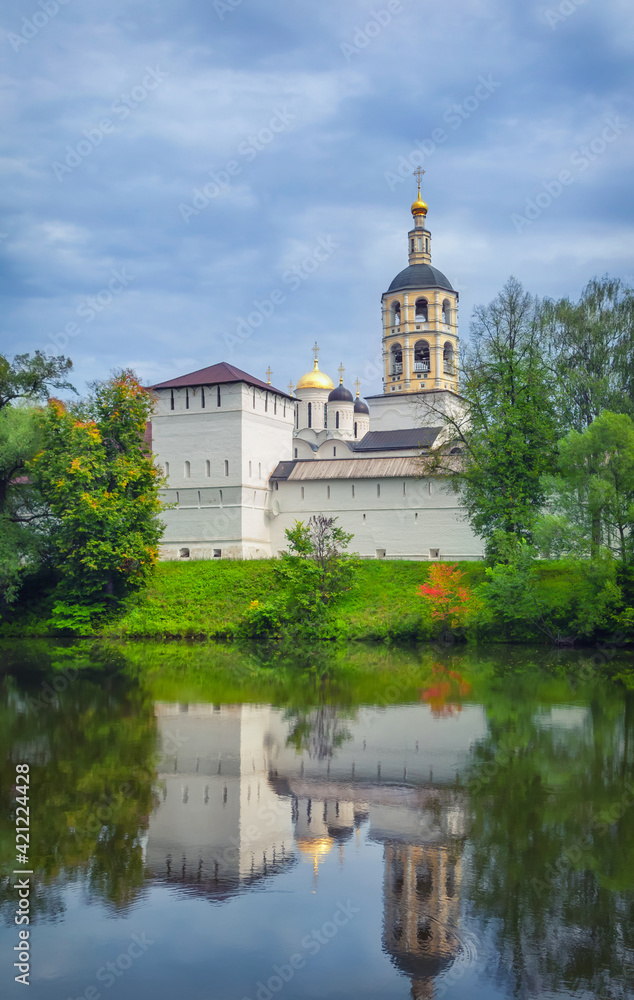 View of St. Paphnutius of Borovsk Monastery reflecting in water, Kaluga oblast, Russia