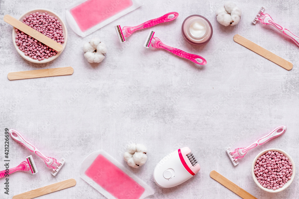 Flat lay of pink epilator with wax strips and razor. Spa cosmetic treatments. Flat lay of pink epilator with wax strips and razor. Spa cosmetic treatments.