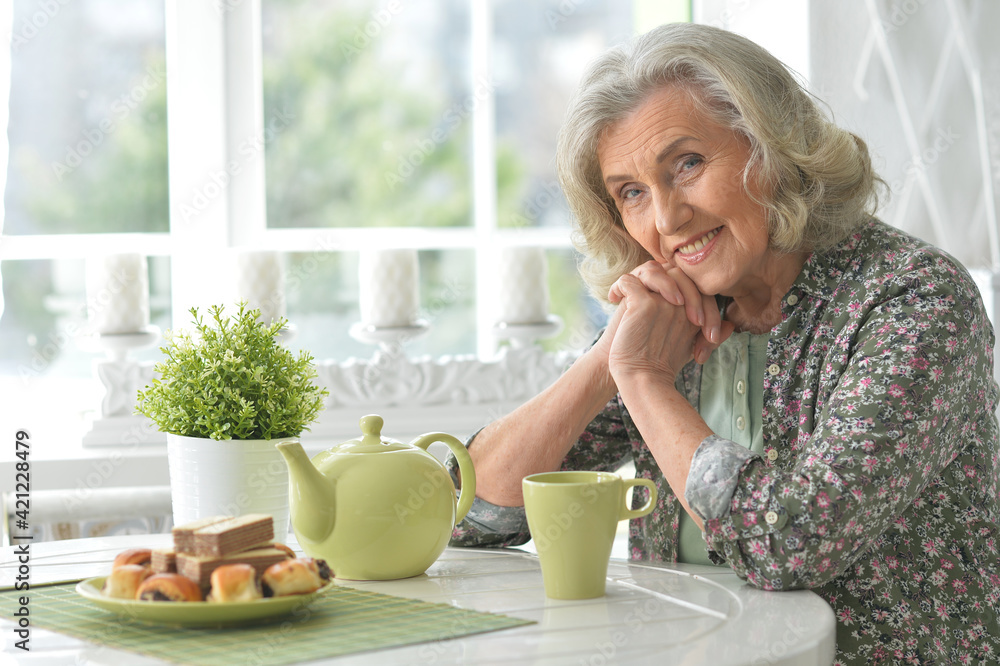 Beautiful smiling senior woman drinking tea