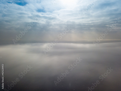 Aerial high view. Flying over the clouds.