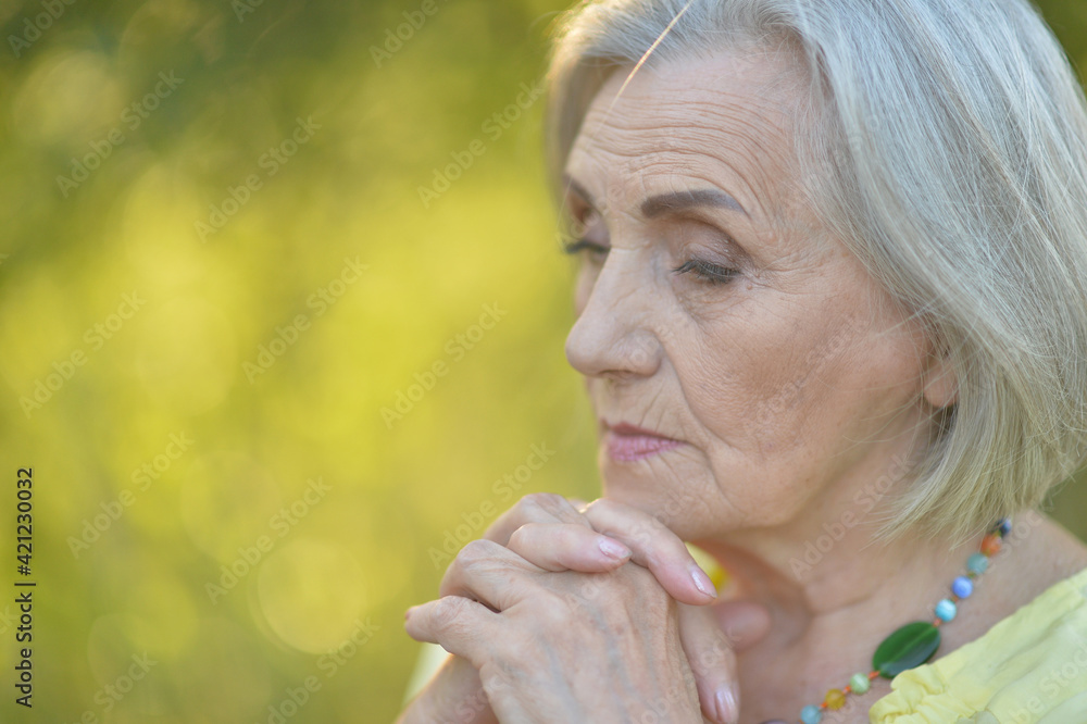 Portrait of sad senior beautiful woman in park Portrait of sad senior beautiful woman in park