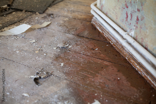 Wallpaper Mural Dirty old building plank floor in front of a bare wall and heating pipe system during the renovation. Refurbishing building dust, condominium, moving floor corona lockdown Torontodigital.ca