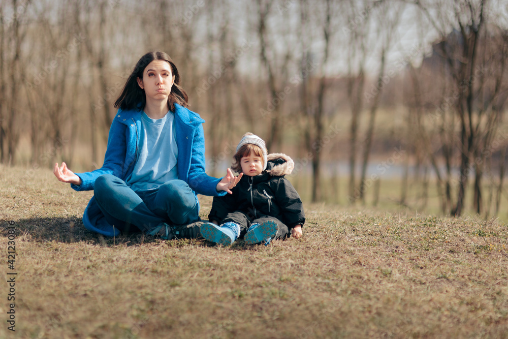 Fototapeta premium Mother in Lotus Pose Trying to Relax Outside