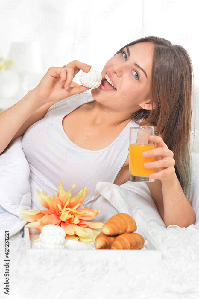 Young beautiful woman having breakfast in bed Young beautiful woman having breakfast in bed