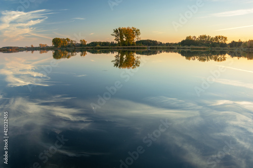 Reflection of white clouds in the water of a calm lake