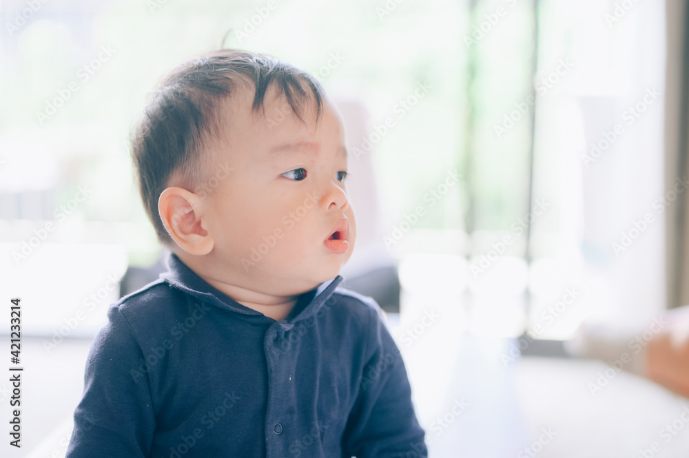 Portrait of a 1 year old baby in bedroom