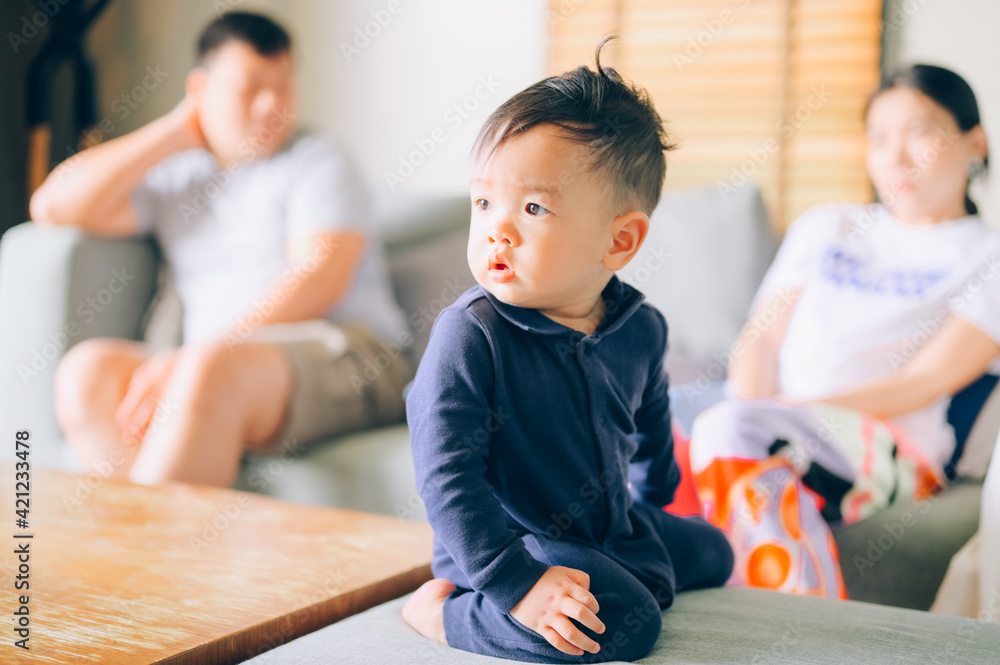Fototapeta premium childhood, sadness and people concept - sad boy and parents arguing at home