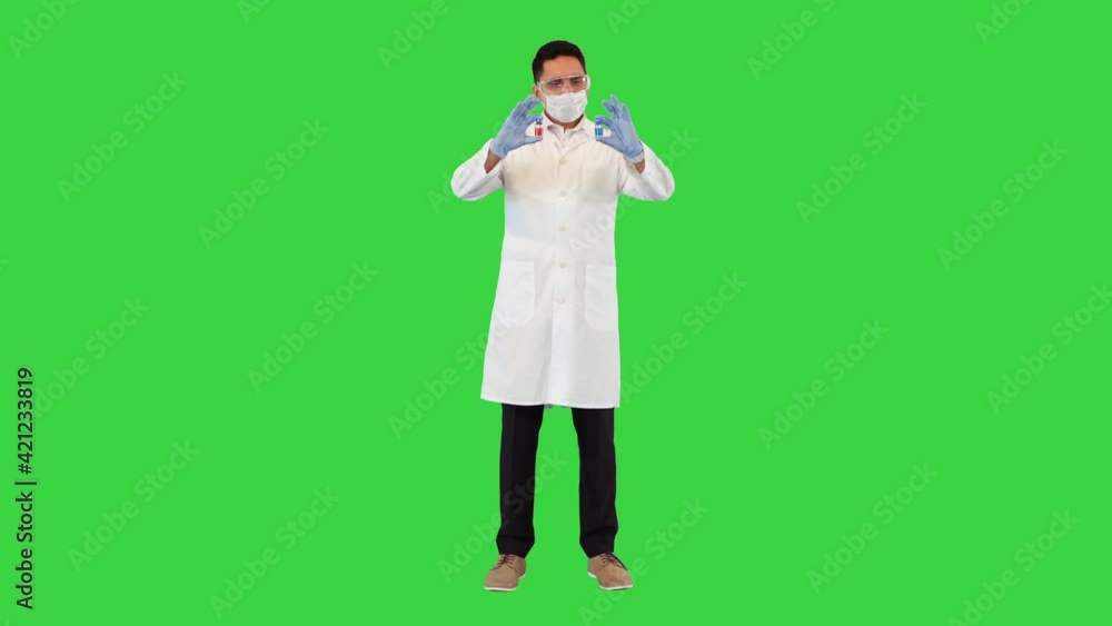 Which treatment, medicine or vaccine would you choose Doctor showing two ampoules with vaccines from covid-19 on a Green Screen, Chroma Key. Which treatment, medicine or vaccine would you choose Doctor showing two ampoules with vaccines from covid-19 on a Green Screen, Chroma Key.