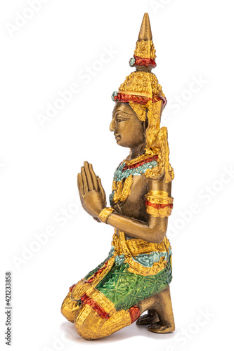 Bronze statue of praying man isolated on white background. Side view
