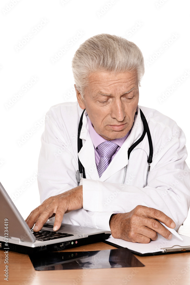 Elderly doctor with a laptop on white background Elderly doctor with a laptop on white background