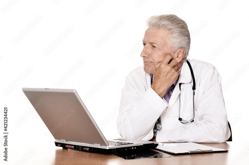 Elderly doctor with a laptop on white background Elderly doctor with a laptop on white background