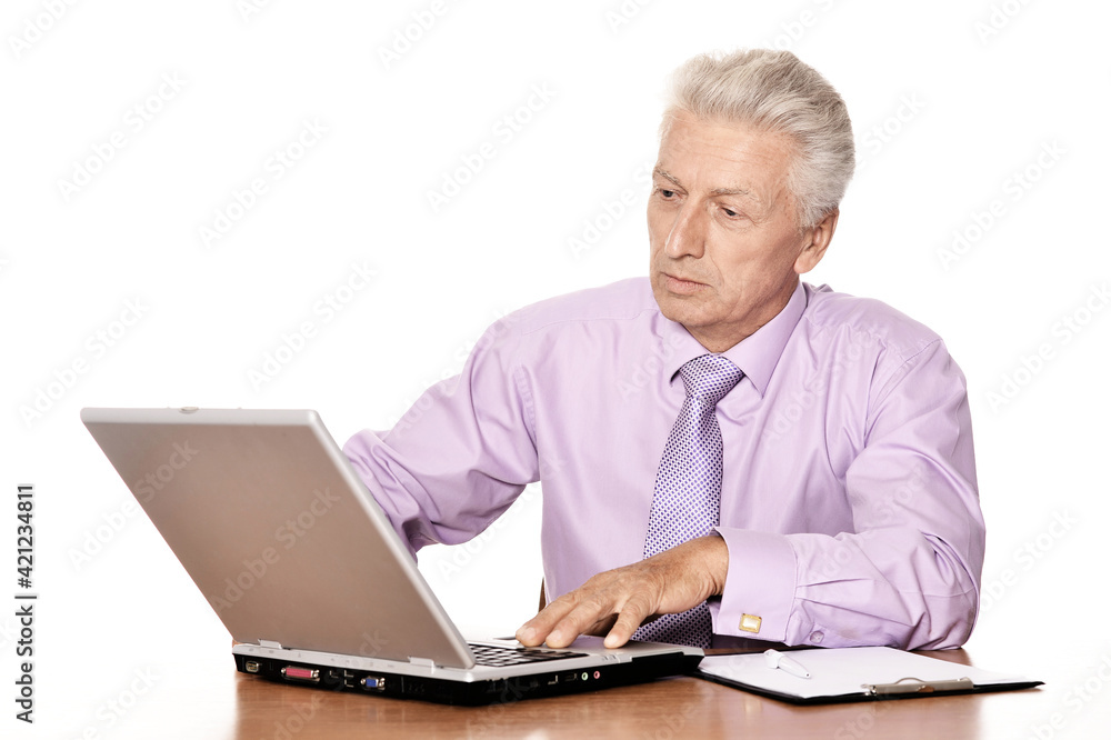 Old businessman working with laptop isolated on white background Old businessman working with laptop isolated on white background