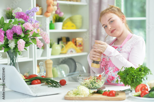 teen girl preparing fresh salad