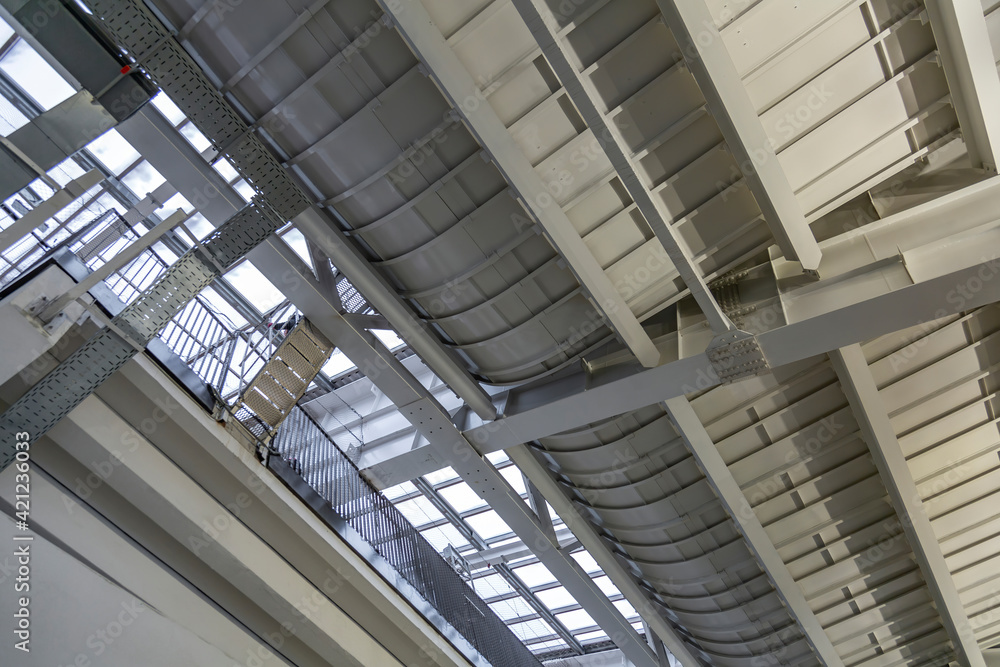 Metal beams and heavy steel piles as part of strengthening and supporting the roof of a building