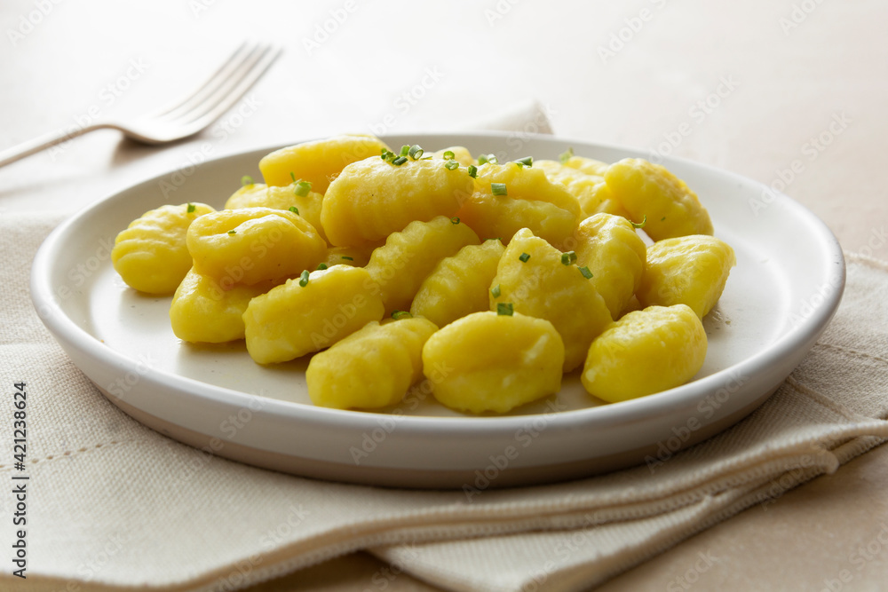 Potato dumplings gnocchi mediterranian food. Cooked gnocchi with butter and green onions.